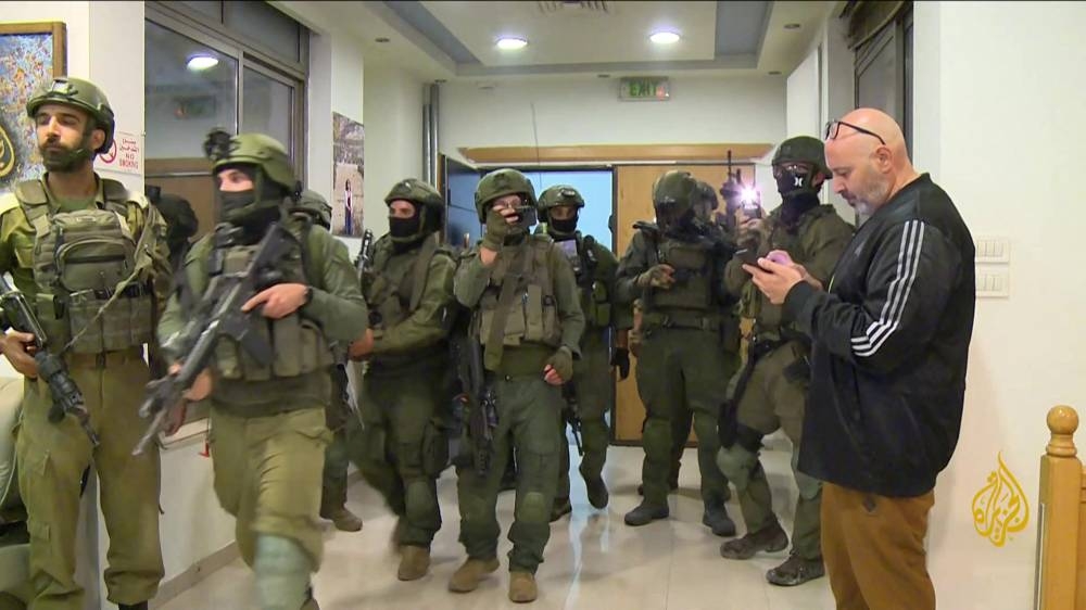 An image grab from footage distributed by Al-Jazeera TV on Sunday shows Israeli soldiers entering Al Jazeera's office in Ramallah, in the West Bank to issue a 45-day closure order on September Saturday. AFP PHOTO / Al-Jazeera