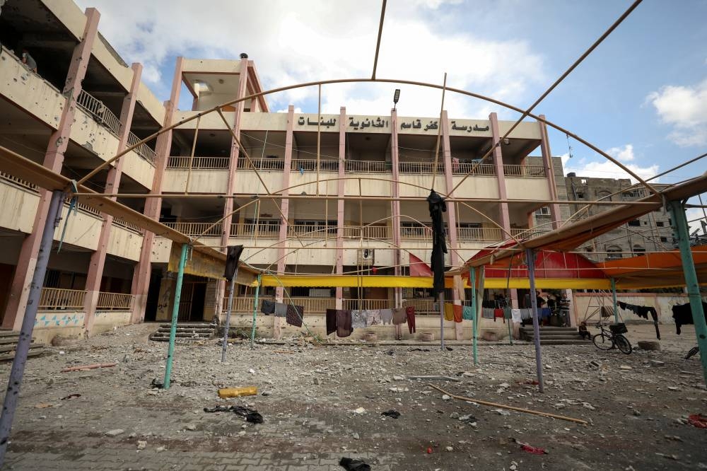 Palestinians view the damage inside a school sheltering displaced people after it was hit by an Israeli strike, at Beach refugee camp in Gaza City, Sunday. REUTERS