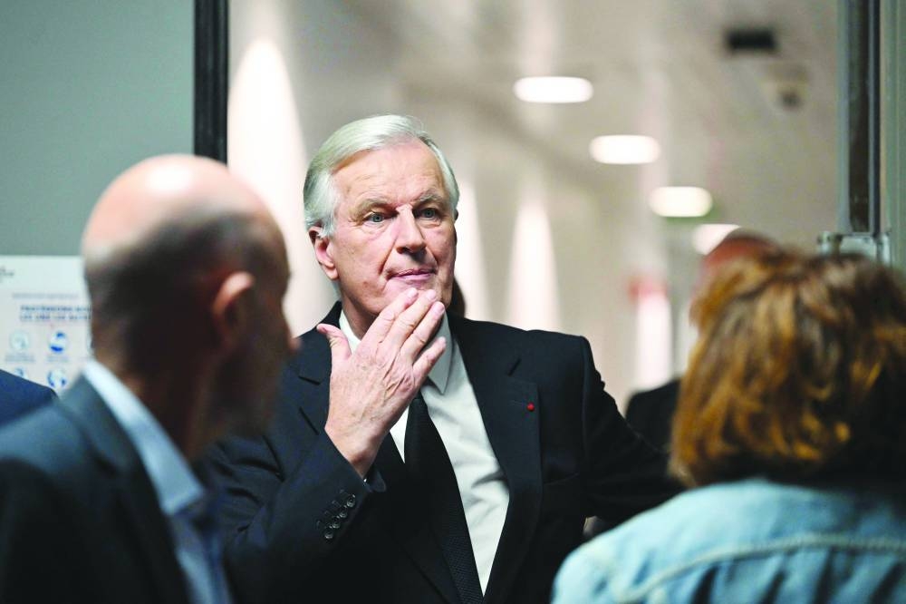 French Prime Minister Michel Barnier arrives to take part in the evening news broadcast of French TV channel France 2 at the France Televisions studios in Paris. (AFP)