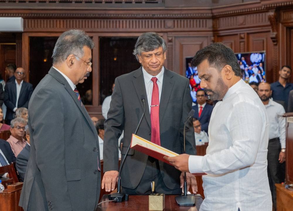 Sri Lanka's newly elected President Anura Kumara Dissanayake reads his oath of office as Chief Justice Jayantha Jayasuriya looks on during the swearing-in ceremony at the Presidential Secretariat, in Colombo, Sri Lanka, on Monday. Sri Lanka President Media/Handout via REUTERS