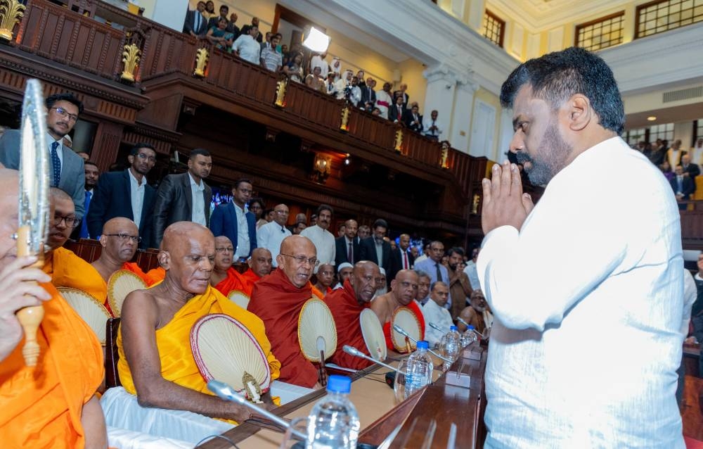 Buddhist monks chant religious hymns as they bless Sri Lanka's new President Anura Kumara Dissanayake after he took his oath of office at the Presidential Secretariat, in Colombo, Sri Lanka, on Monday. Sri Lanka President Media/Handout via REUTERS