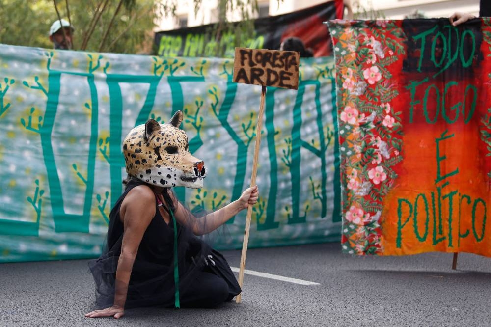 A protestor participates in a march for climate justice and against wild fires affecting the entire country in Sao Paulo, Brazil, on Sunday. AFP