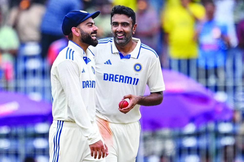 
India’s all-rounder Ravichandran Ashwin (right) celebrates with teammate Virat Kohli after taking the wicket of Bangladesh’s Mehidy Hasan Miraz during the fourth day of the first Test at the MA Chidambaram Stadium in Chennai on Sunday. (AFP) 