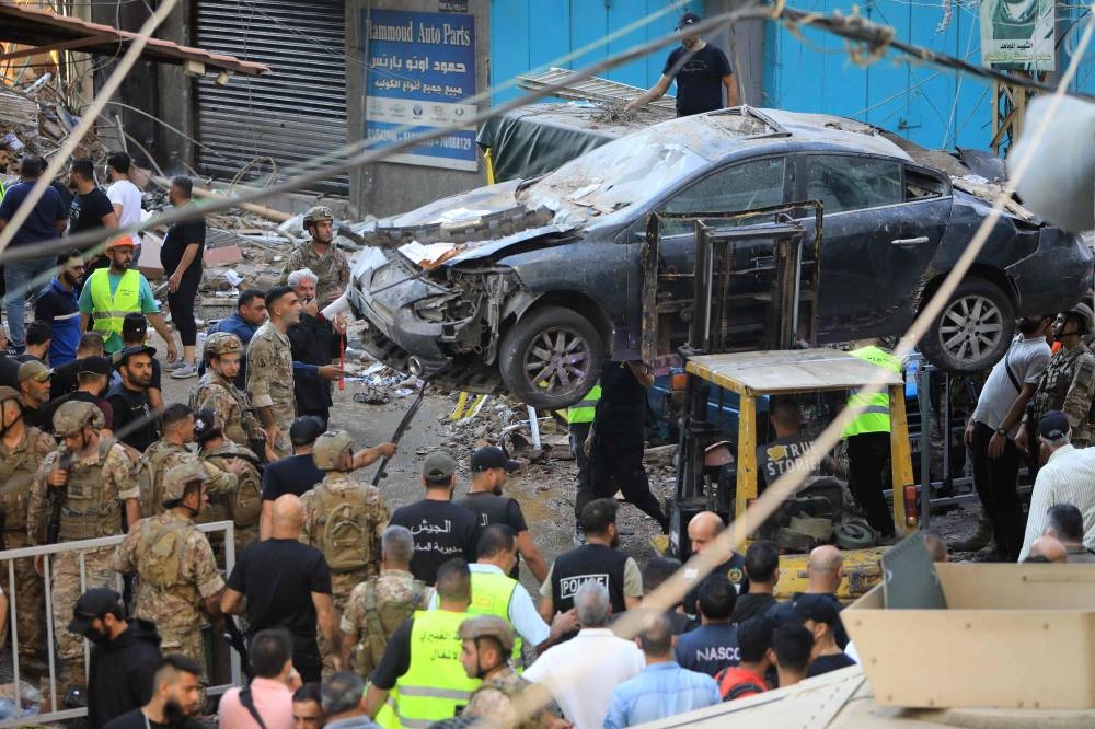 Lebanese army soldiers and rescuers work in a street under a residential building whose top two floors were hit by an Israeli strike in the Ghobeiri area of Beirut's southern suburbs on Tuesday. AFP