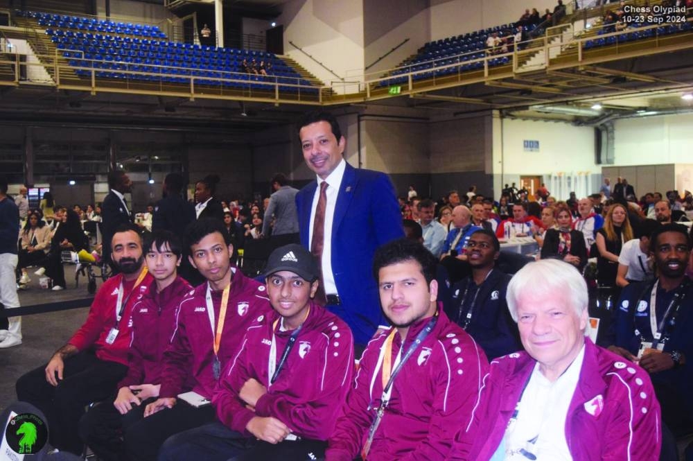 
Mohammed al-Mudahka, President of the Qatar Chess Association, is seen with the Qatari players delegation at the FIDE Chess Olympiad in Budapest, Hungary. Right: The Qatari chess players pose on the podium. 
 