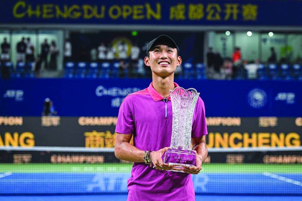 China’s Shang Juncheng holds the trophy after winning the singles final against Italy’s Lorenzo Musetti at the ATP Chengdu Open in Chengdu, in China’s southwestern Sichuan province, on Tuesday. (AFP)