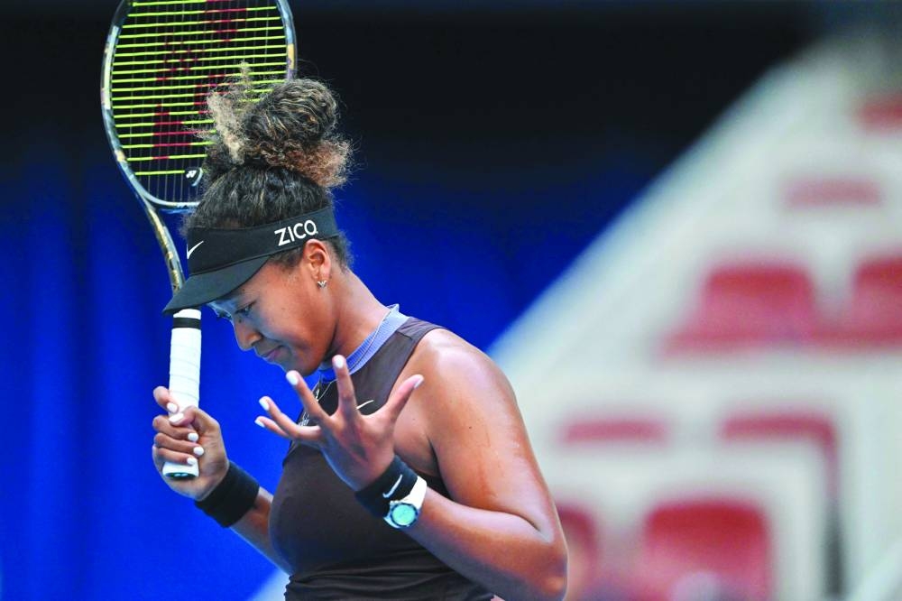 Japan’s Naomi Osaka reacts with new coach Patrick Mouratoglou (inset) watching from the stands as she plays against Italy’s Lucia Bronzetti during their singles match at the China Open in Beijing on Wednesday. (AFP)