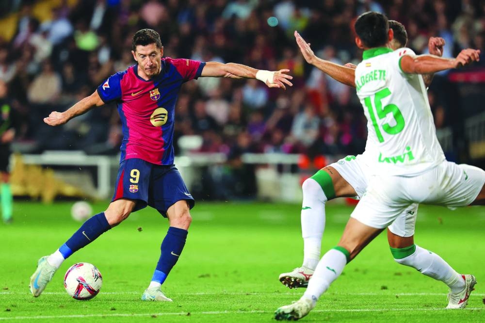 Barcelona's Polish forward #09 Robert Lewandowski kicks the ball during the Spanish league football match between FC Barcelona and Getafe CF at the Estadi Olimpic Lluis Companys in Barcelona on September 25, 2024. (Photo by LLUIS GENE / AFP)