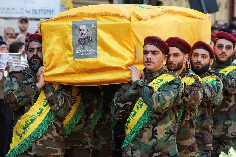 Pallbearers carry the coffin of Mohammad Surur, head of one of Hezbollah's air force units who was killed in Israel's strike on Beirut's southern suburbs on Thursday, during the funeral of Mohammad Surur and two other Hezbollah members Hussein Aweleh and Khodr Atwi, in Beirut's southern suburbs, on Friday. REUTERS