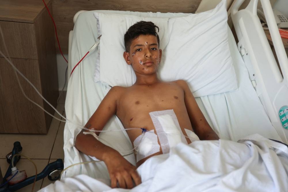 Abdallah Tawfik al-Hamid, 13, a Syrian boy who was wounded in a recent Israeli strike, receives treatment in a hospital in Sarafand, Lebanon, on Friday. REUTERS