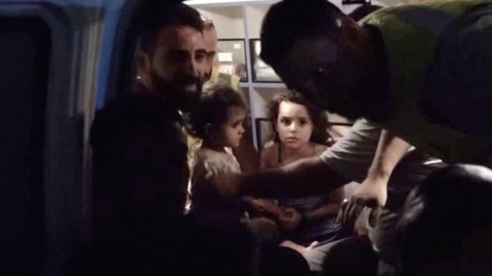 Children that were rescued from the rubble following an Israeli strike sit inside an ambulance, in Beirut, Lebanon Friday, in this still image obtained from handout video.  AL MANAR/Handout via REUTERS