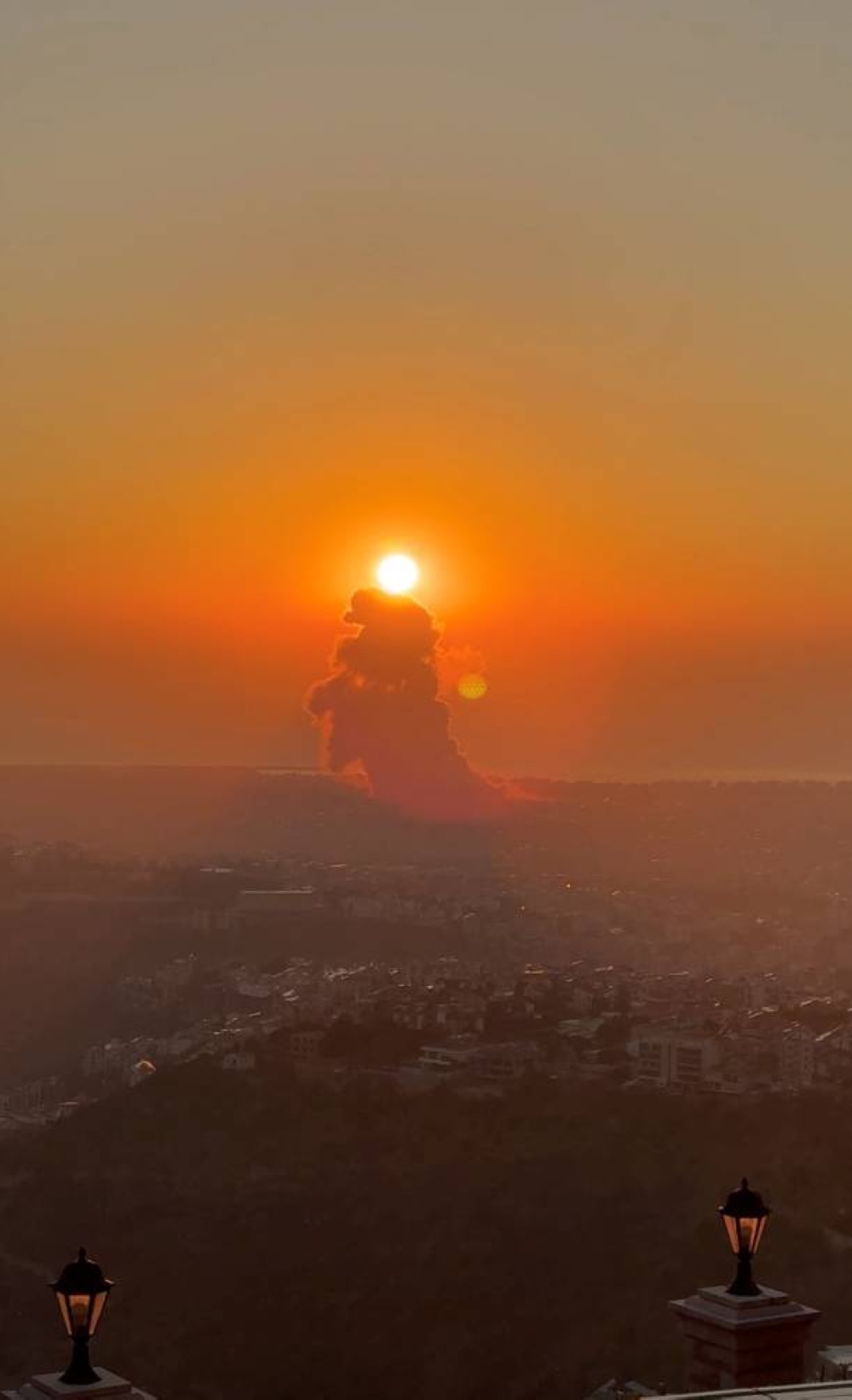 Smoke rises above buildings in Beirut, as seen from Beit Mery, Lebanon Friday, in this still image obtained from social media video.  CIELA.TRAVELS VIA INSTAGRAM/via REUTERS
