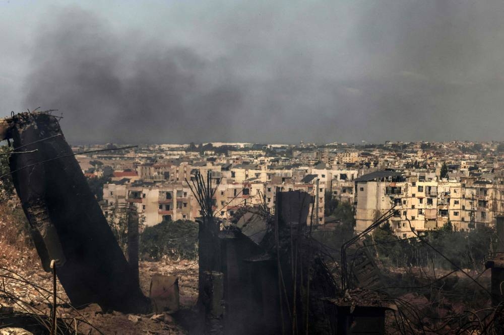 Smoke rises from a factory destroyed in an overnight Israeli airstrike in the town of Chouaifet south of Beirut on on Saturday. AFP