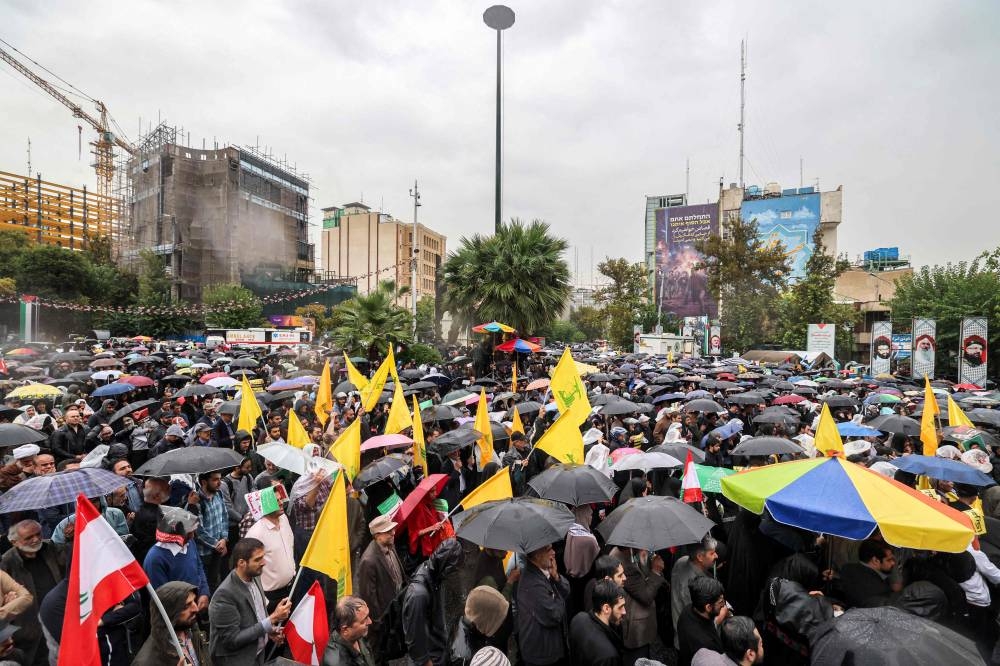 Demonstrators gather in the rain for an anti-Israel protest in Tehran's Palestine Square on Saturday. AFP