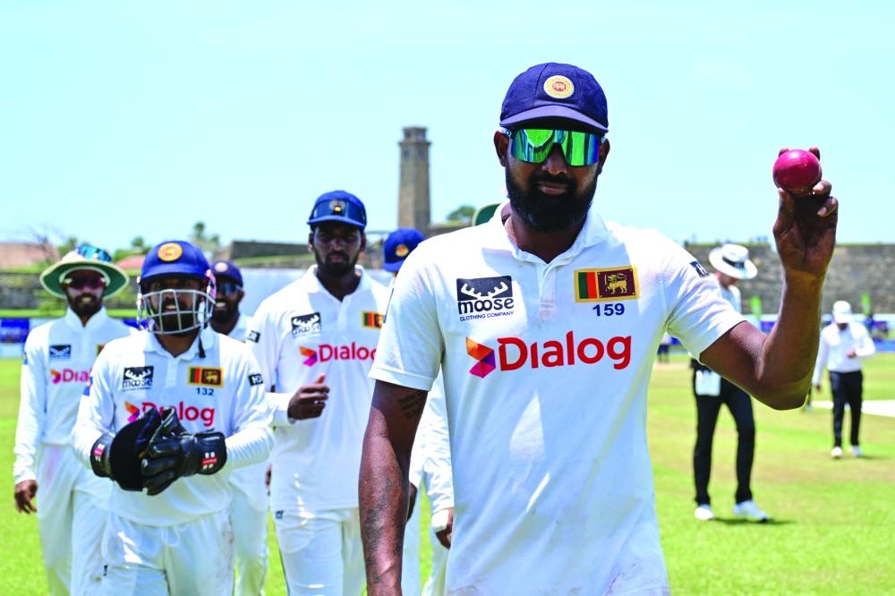 Sri Lanka’s Prabath Jayasuriya celebrates after taking a five-wicket haul during the third day of the second Test against New Zealand at the Galle International Cricket Stadium in Galle on Saturday. (AFP)