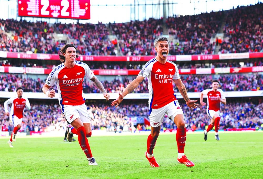 Arsenal’s Leandro Trossard celebrates scoring their third goal with Riccardo Calafiori during their Premier League match against Leicester City at Emirates Stadium, London, Britain, on Saturday. (Reuters)