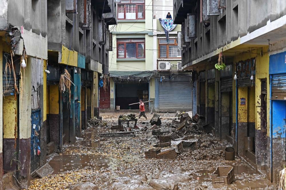 A man walks through a flood-affected area following heavy monsoon rains at a fruit market in Kathmandu, on Sunday. REUTERS