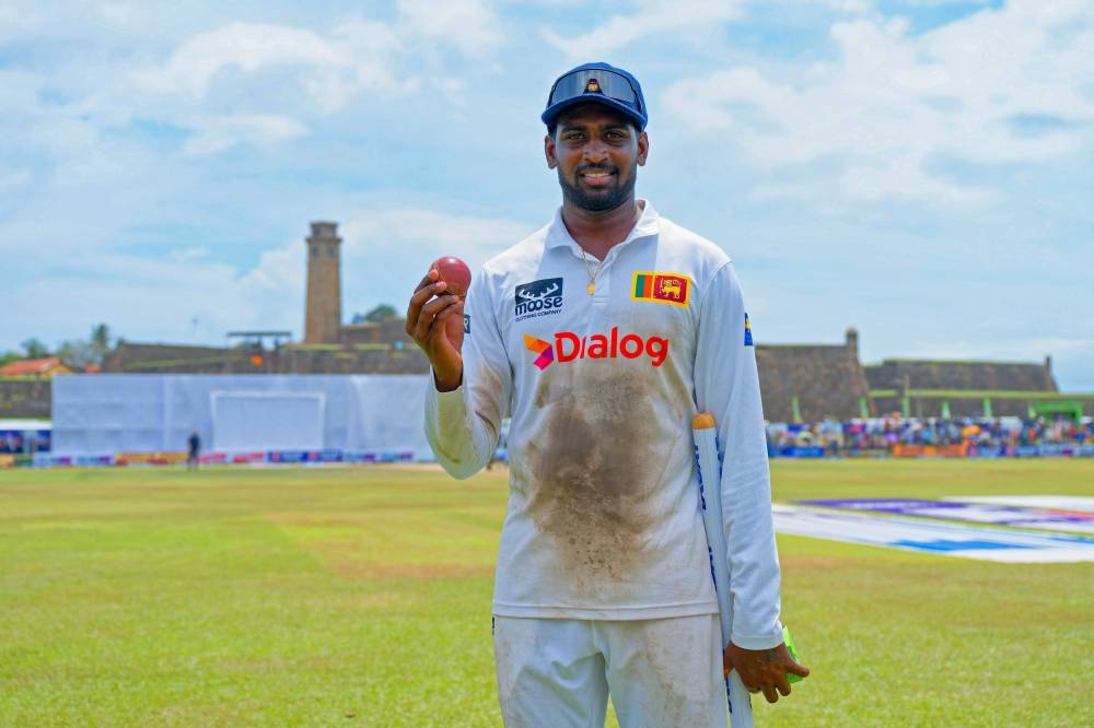 Sri Lanka's Nishan Peiris celebrates after taking five-wicket haul during the fourth day of the second Test against New Zealand at the Galle International Cricket Stadium in Galle yesterday. (AFP)