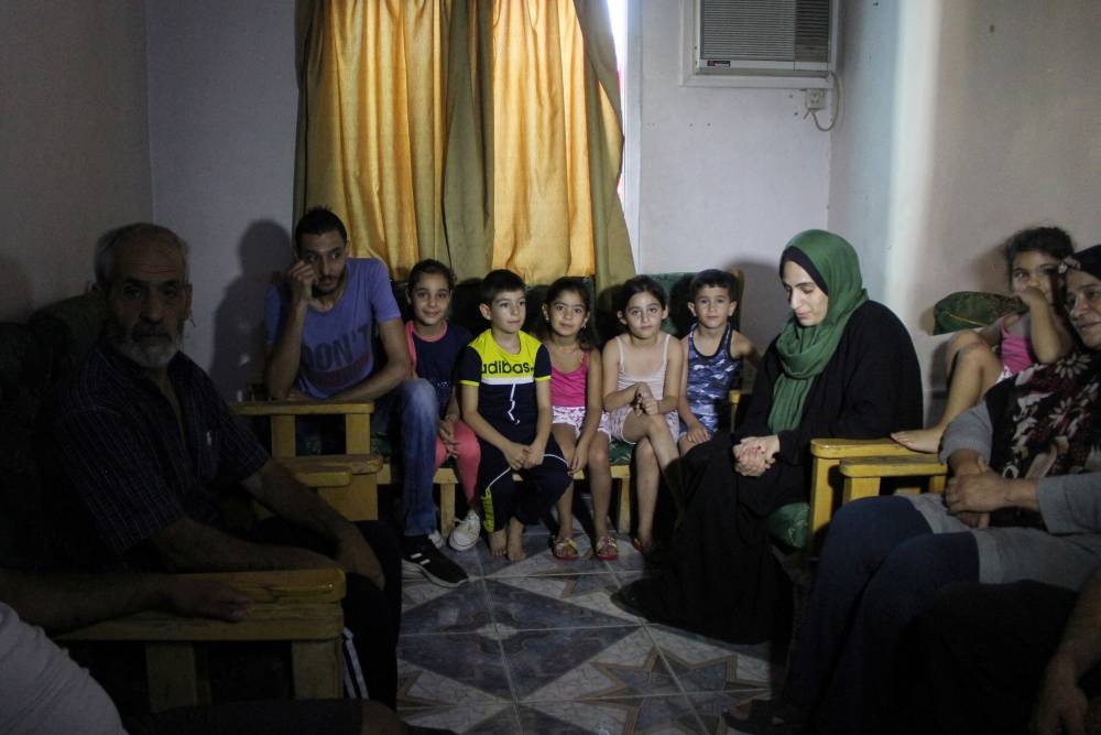 Relatives of Abbas Dalloul, a Lebanese man who fled Lebanon with his 20-member family to safety in Syria, sit in a shelter, amid the ongoing hostilities between Hezbollah and Israeli forces, in the village of Sayyedah Zeinab, Syria, Sunday. REUTERS