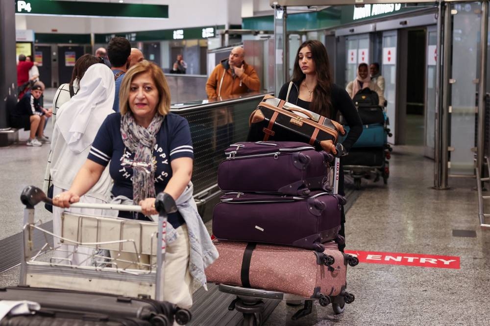 Passengers arriving from Beirut, amid the ongoing hostilities between Hezbollah and Israeli forces, walk inside the arrival terminal of Malpensa airport in Milan, Italy, on Monday. REUTERS