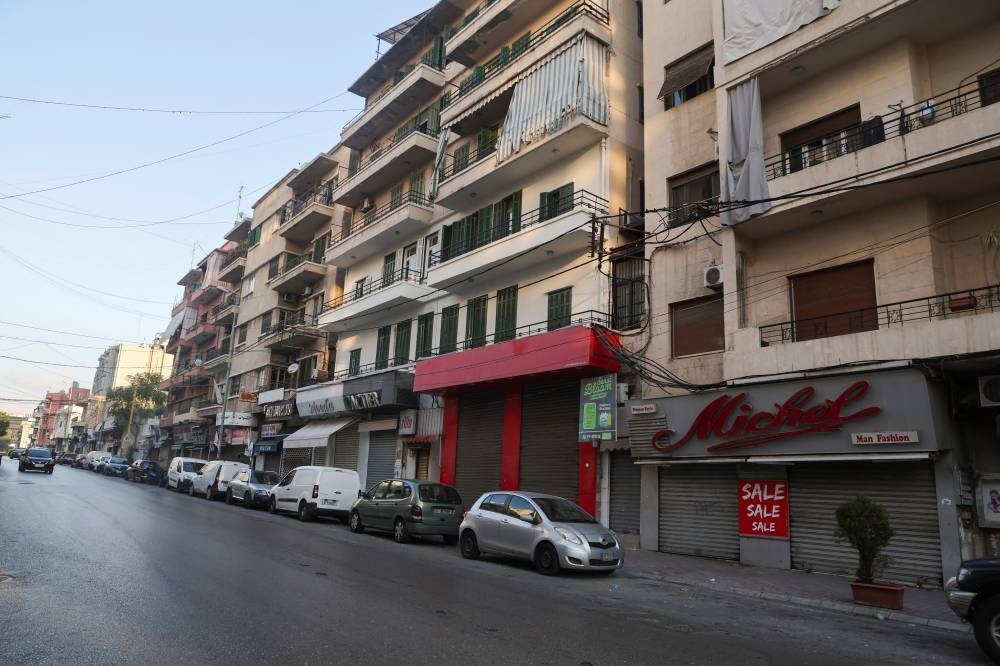 Vehicles are parked next to closed shops on a street, amid ongoing hostilities between Hezbollah and Israeli forces, in Beirut, Lebanon, on Monday. REUTERS
