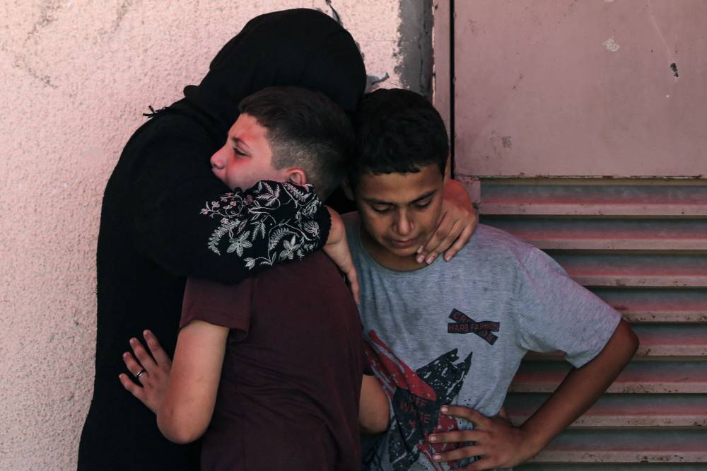 Palestinians mourn the death of a relative killed in Israeli strikes on Al-Bureij refugee camp, at the Al-Aqsa Martyrs hospital in Deir el-Balah in the central Gaza Strip on Monday. AFP