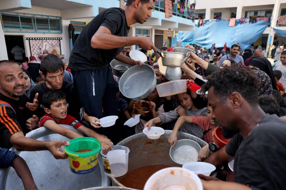 Palestinian children receive food at a UN-run school in Rafah, on the southern Gaza Strip on October 23, 2023. File picture: AFP