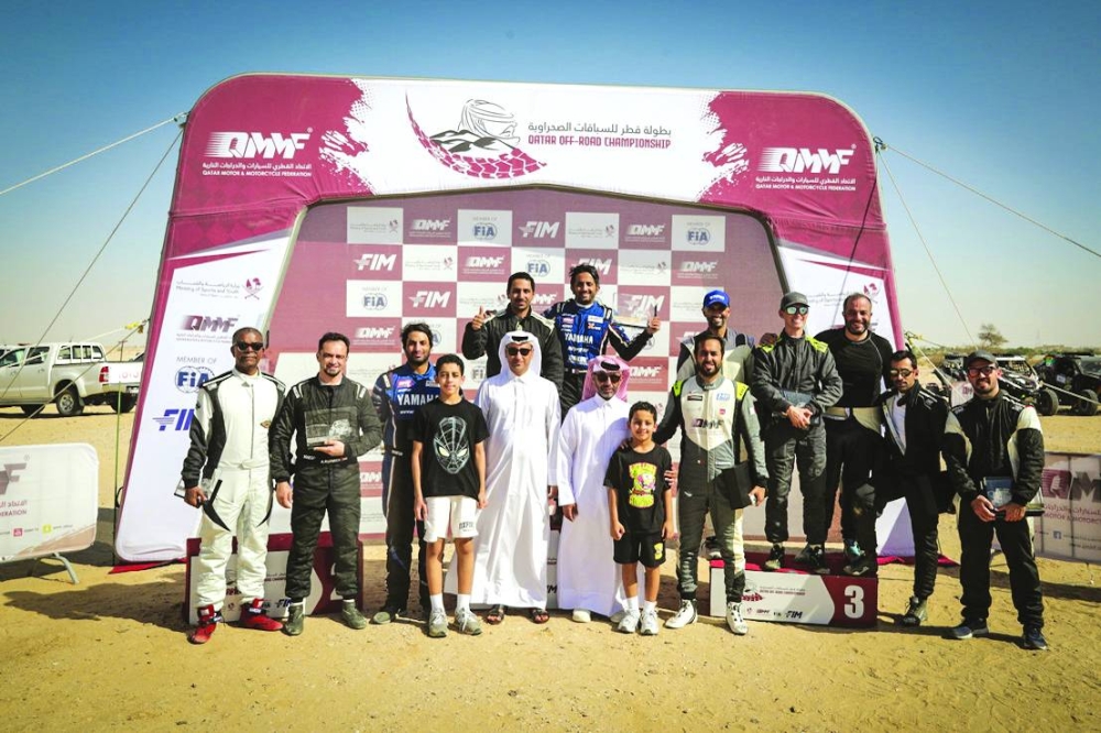 Podium winners of the Cars categories of the Qatar Off-Road Championship pose with the officials.