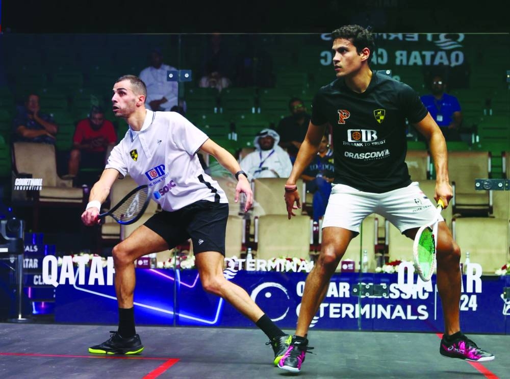 World number one and the defending champion Ali Farag of Egypt and compatriot Youssef Ibrahim in action during their opening round match at the QTerminals Qatar Classic at the Khalifa International Tennis & Squash Complex in Doha on Monday. Farag won 11-7, 11-5, 11-7. Right: Qatar’s Abdulla al-Tamimi goes for a low retrieve against England’s Adrian Waller. 
Al-Tamimi won 11-9, 11-13, 11-2, 12-10 to advance to the second round.