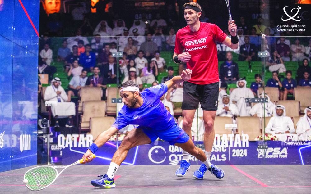 Qatar's Abdulla al-Tamimi goes for a low retrieve against England's Adrian Walker during their Q-Terminals Qatar Classic match at the Khalifa Tennis and Squash Complex in Doha on Monday. Al-Tamimi won 11-9, 11-13, 11-2, 12-10 to advance to the second round.