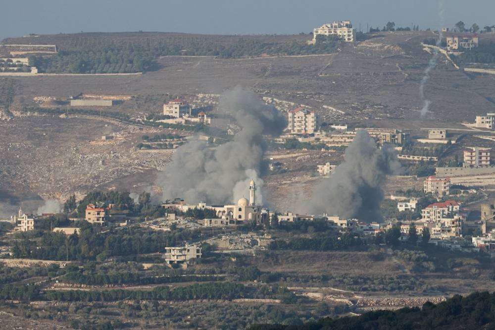 Smoke billows after an Israeli Air Force air strike on a village in southern Lebanon as seen from northern Israel on Tuesday. REUTERS