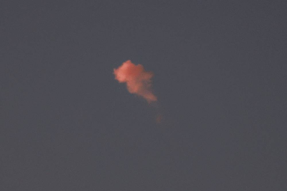 A cloud of smoke after a projectile was intercepted by Israel above Jerusalem on Tuesday. AFP