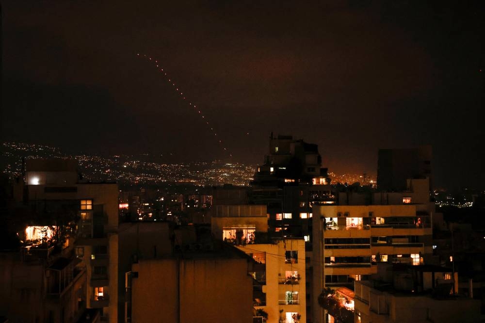 Tracers from firearms fired into the air  in celebration for Iran's missiles barrage on Israel, are seen over Beirut, Lebanon, on Tuesday. REUTERS