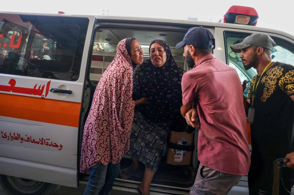 Palestinians transport casualties of an Israeli bombardment on a displacement camp in Khan Yunis in the southern Gaza Strip, to the Nasser hospital on Tuesday. AFP