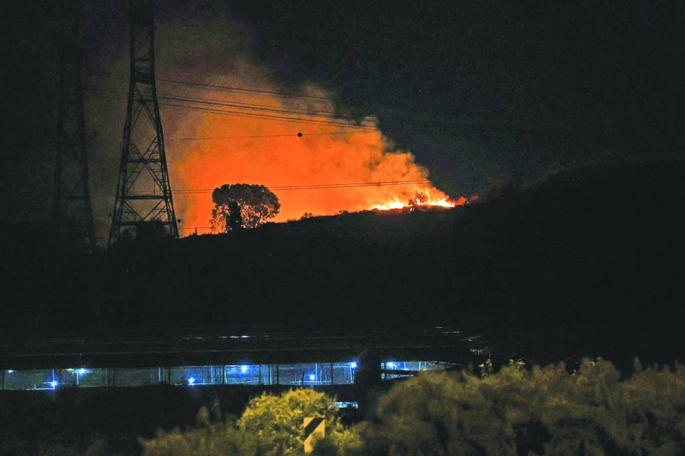 Fire erupts between Ben Gurion International Airport near Tel Aviv and the city of Modiin following an Iranian missile attack Tuesday.