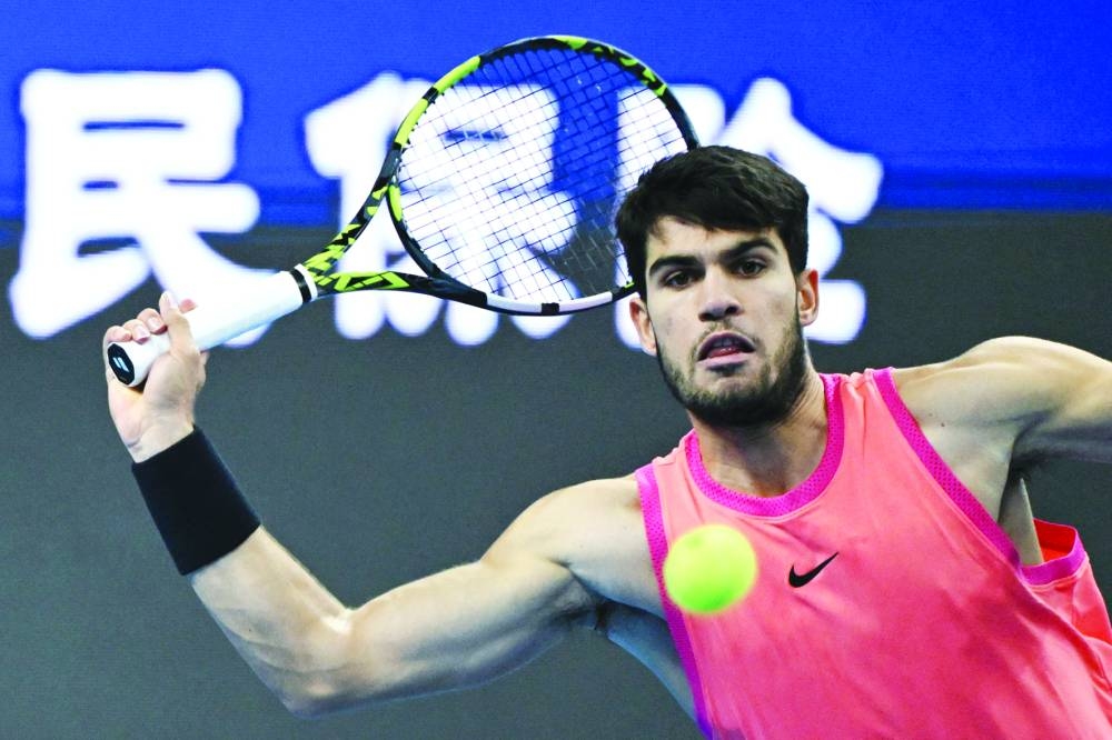 Spain’s Carlos Alcaraz hits a return to Russia’s Daniil Medvedev during their semi-final at the China Open in Beijing on Tuesday. (AFP)