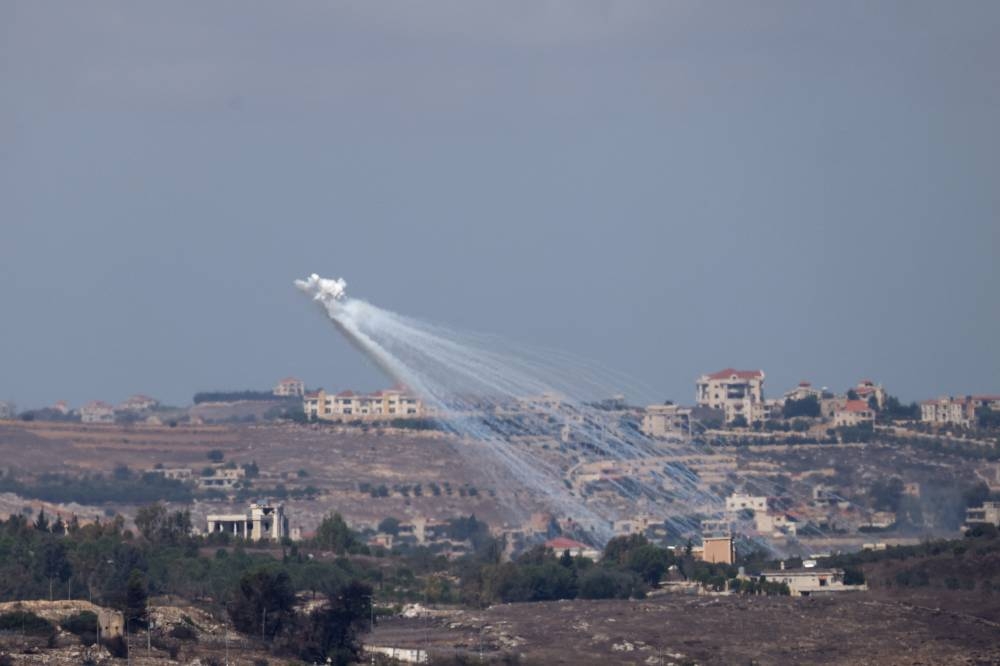 Artillery is fired by the Israeli army into Lebanon, as seen from Jish, northern Israel, on Wednesday. REUTERS
