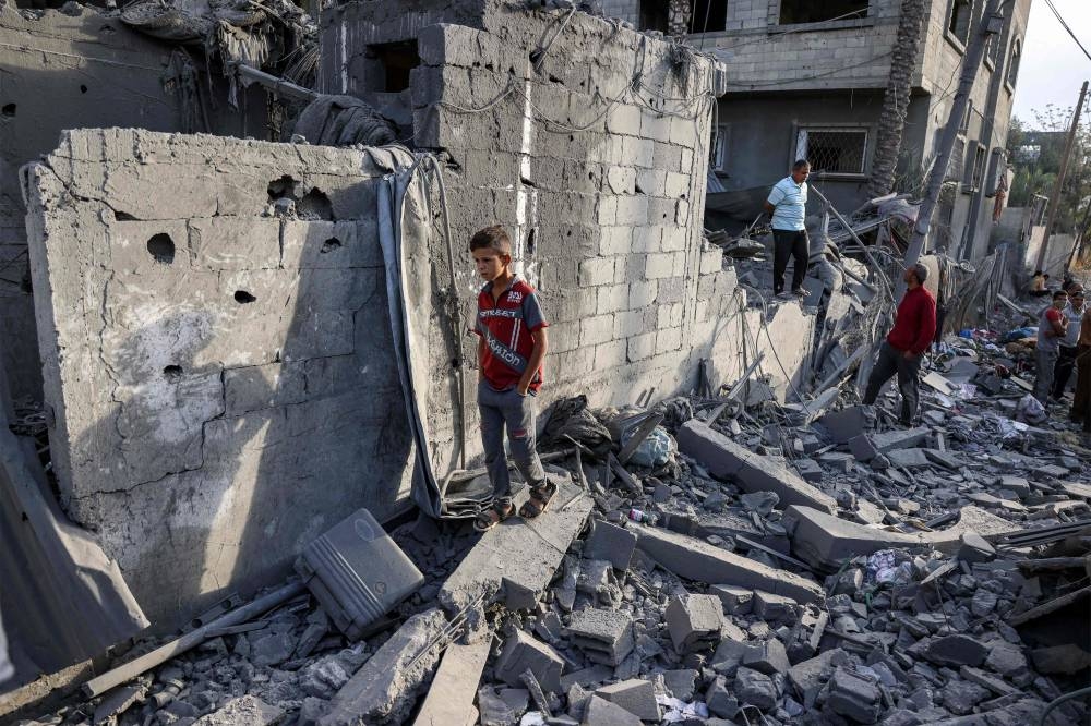 A boy walks through the rubble of a collapsed building in Khan Yunis in the southern Gaza Strip on Wednesday. AFP