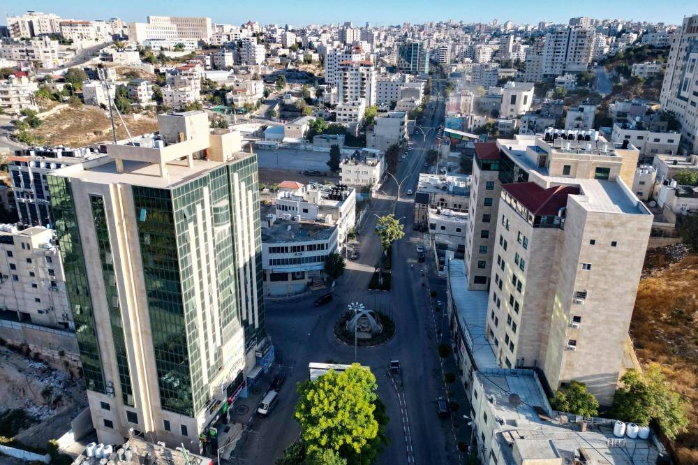 An aerial view shows a deserted street in the occupied West Bank city of Hebron after a call for a strike a day after an Israeli air raid on the refugee camp of Tulkarm that reportedly killed 18 Palestinians, on Friday. AFP