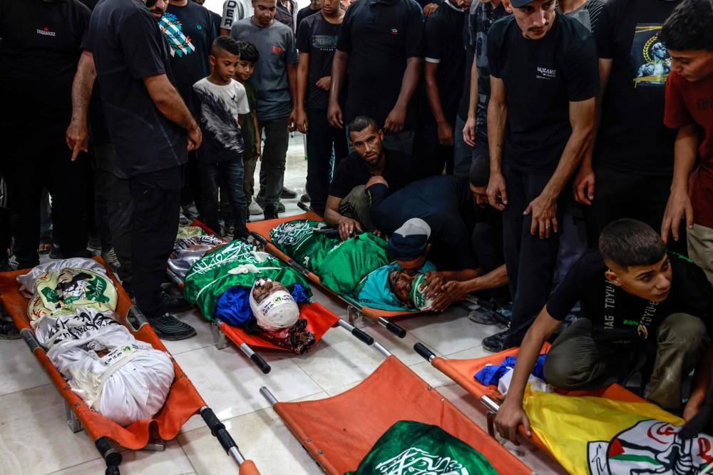 Mourners pray by the bodies of Palestinians killed in an Israeli airstrike on the Tulkarem refugee camp the previous night, during their funeral procession at the camp in the occupied West Bank, on Friday. AFP