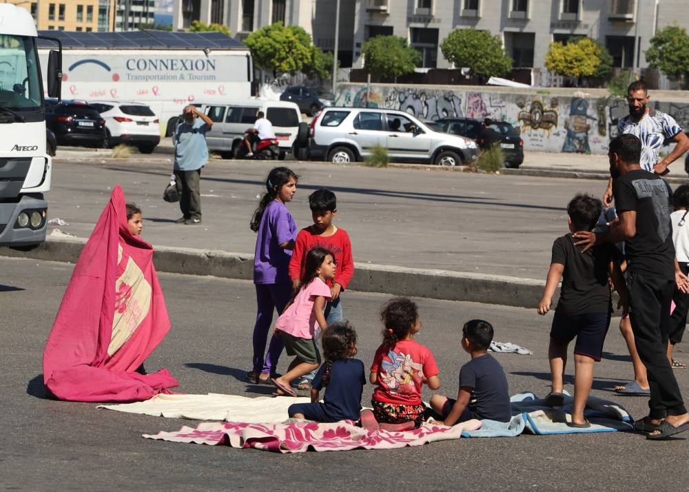 People block a road near Mohammad Al-Amin mosque, after Friday prayers, in Beirut, on Friday. REUTERS