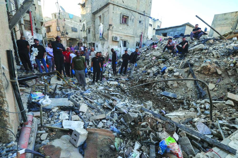 Palestinians inspect the damage at the site of an overnight Israeli airstrike on the Tulkarem refugee camp in the northern occupied West Bank on Friday.