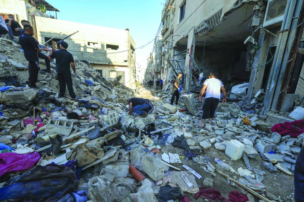 Palestinians inspect the damage at the site of an overnight Israeli airstrike on the Tulkarem refugee camp in the northern occupied West Bank on Friday.