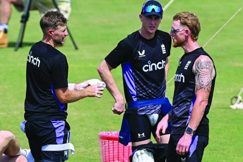 
England’s captain Ben Stokes (right) with teammates Joe Root (left) and Harry Brook attend a practice session at the Multan Cricket Stadium in Multan ahead of their first Test against Pakistan starting on Monday. (AFP) 
