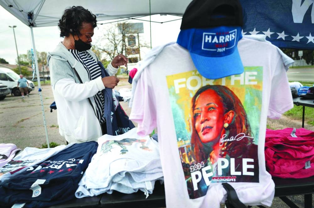 
Right: A vendor sells merchandise near the Dort Financial Centre before the start of a rally with Democratic presidential nominee Vice-President Kamala Harris in Flint. – AFP 