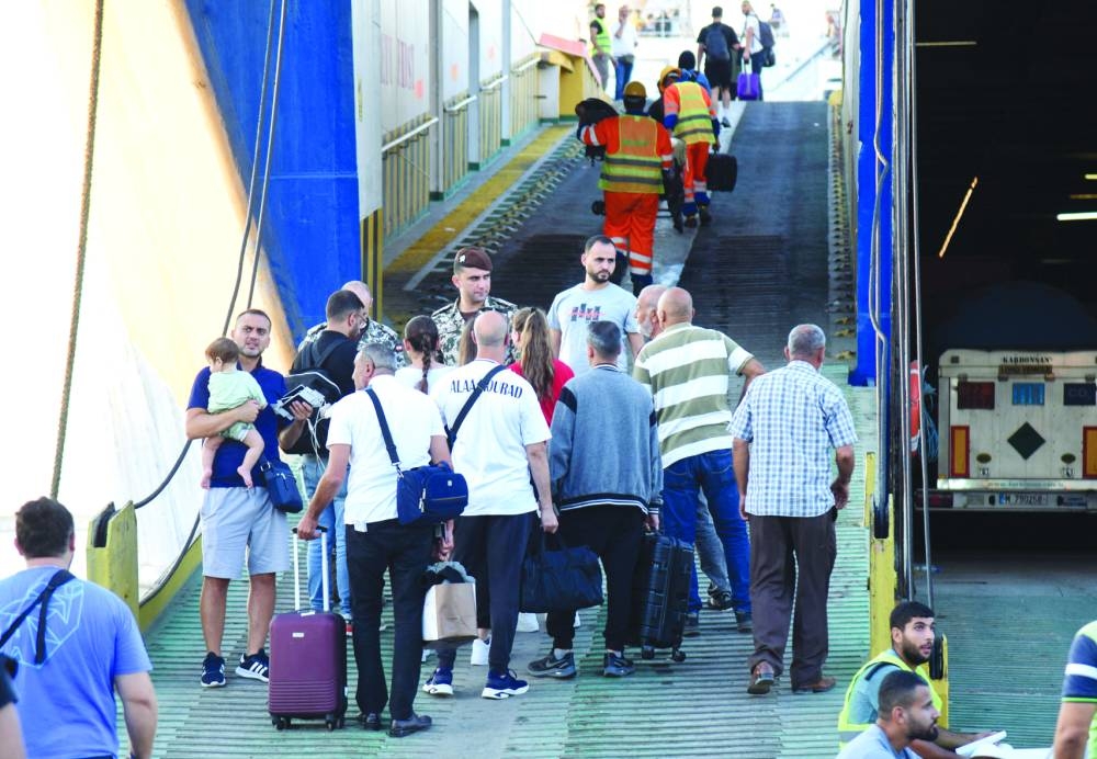 People board a ferry heading to Turkiye, amid the ongoing hostilities between Hezbollah and Israeli forces, in Tripoli, northern Lebanon, Saturday