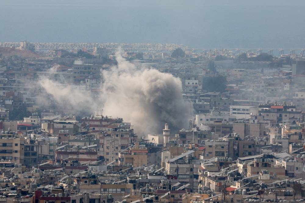 Smoke rises from Beirut's southern suburbs after a strike, as seen from Hadath, Lebanon, on Sunday. REUTERS