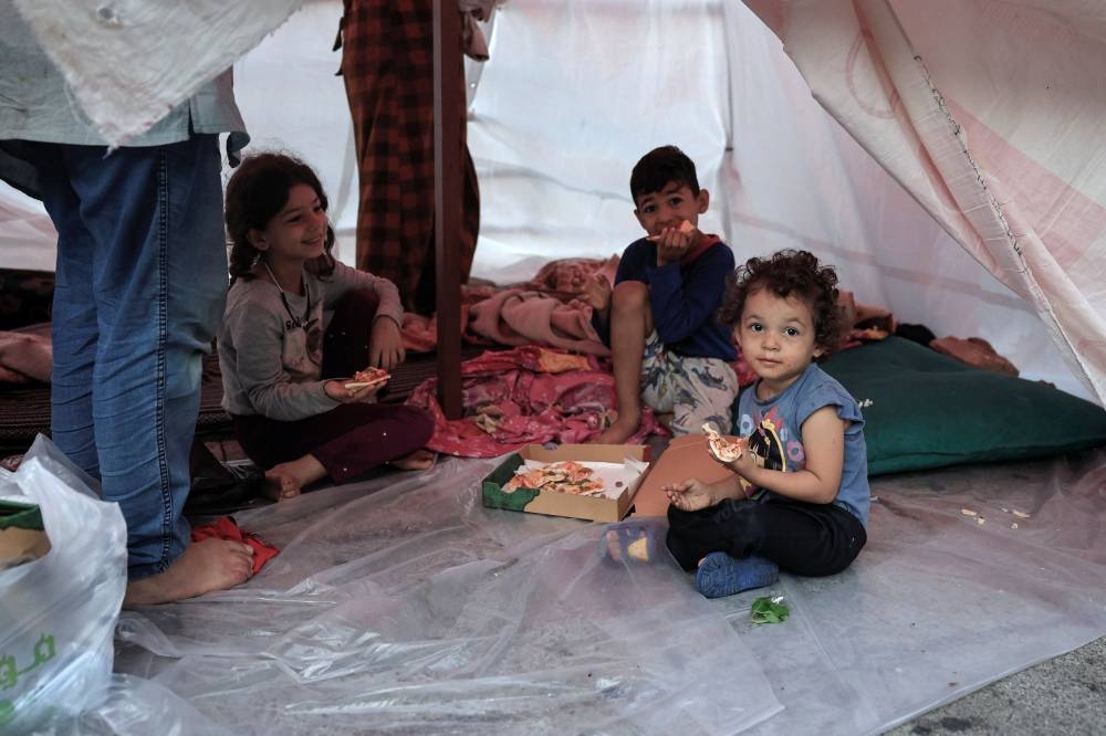 A displaced family sits in their makeshift shelter along the seaside in western Beirut, on Sunday. REUTERS