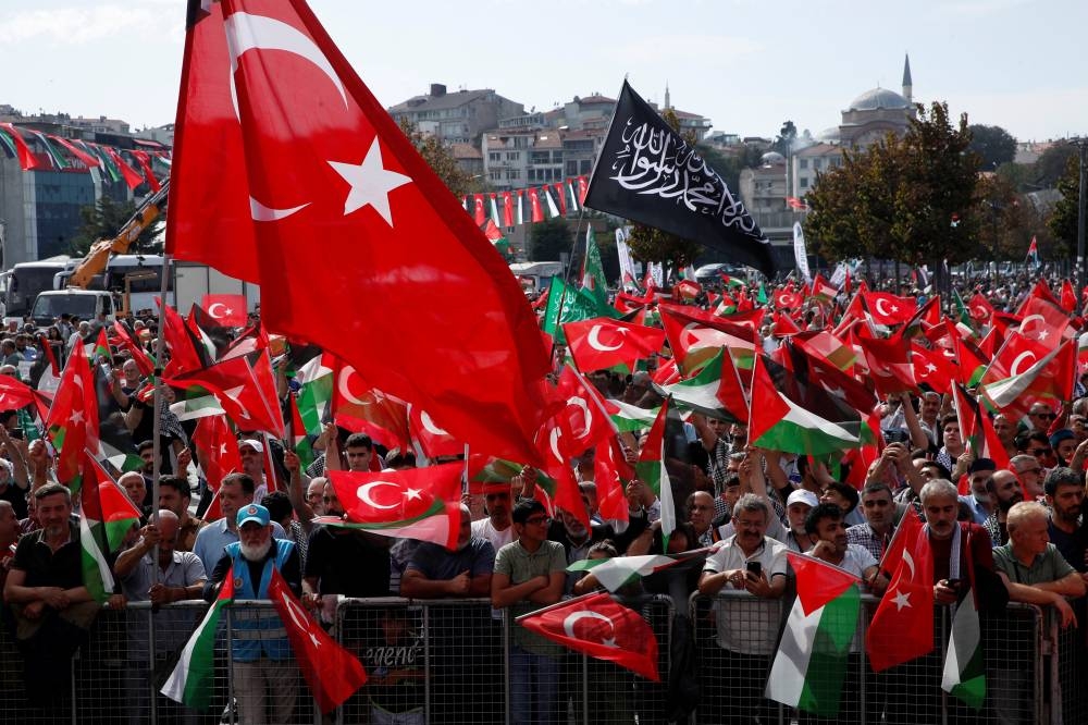 Demonstrators wave Turkish and Palestinian flags during a protest to express support for Palestinians in Gaza in Istanbul, Turkey, on Sunday. REUTERS