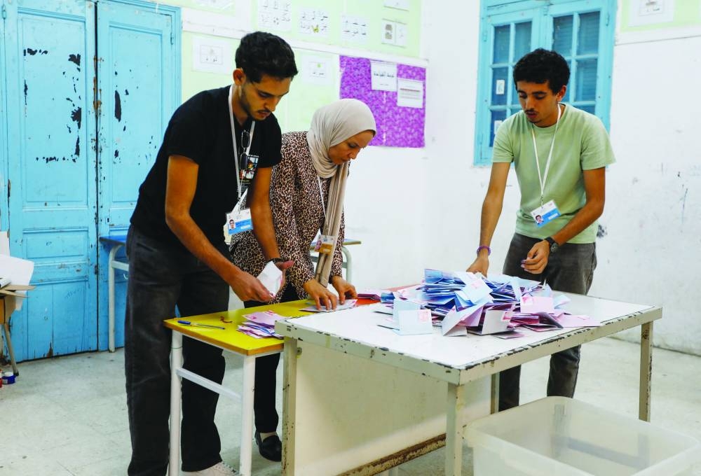 Election officials work at a polling station, during the presidential election in Tunis, yesterday.